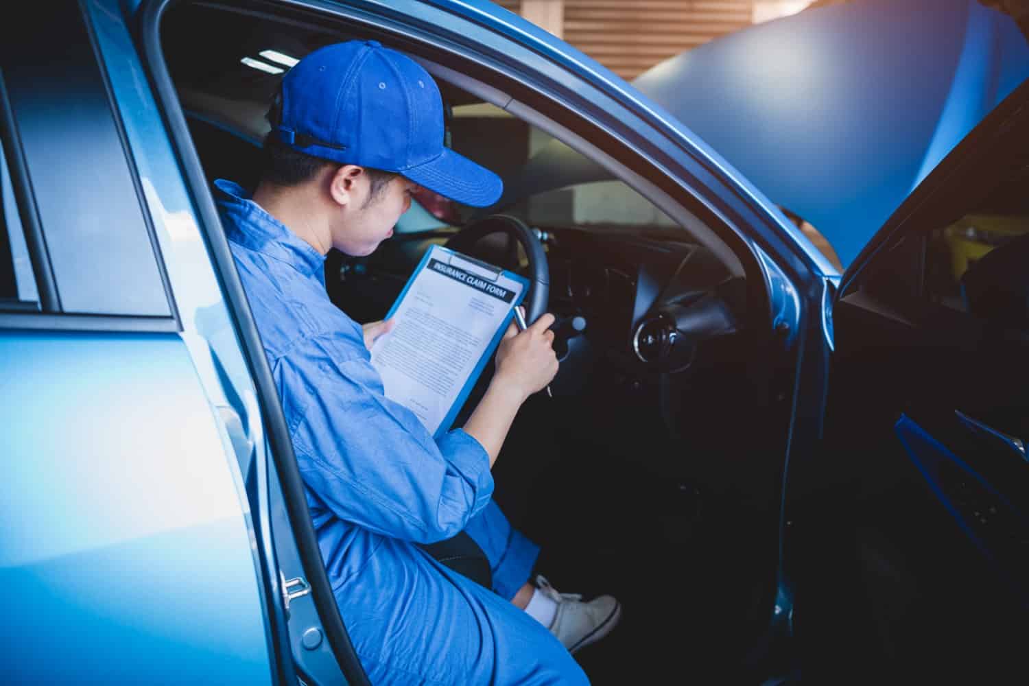 Check up stock-photo-mechanic-holding-clipboard-and-checking-inside-car-to-maintenance-vehicle-by-customer-claim-order-1585533211-min